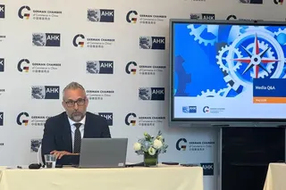 Oliver Oehms, executive director and board member of the German Chamber of Commerce in North China, discusses flash-survey results during a press conference in Beijing on Tuesday afternoon. Photo: Karen Tian