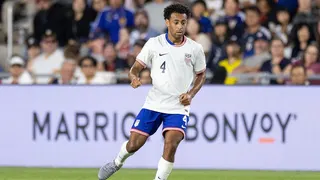 Tyler Adams advancing the ball during a soccer game at Lower.com Field in Columbus, Ohio