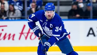 Auston Matthews skating with the puck on ice at Scotiabank Arena