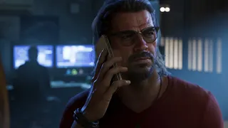 Raul Bautista answering a phone near a computer in GTA 6.