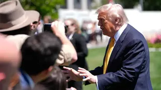 President Donald Trump takes questions from reporters on White House lawn