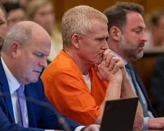 man in orange jumpsuit in courthouse.