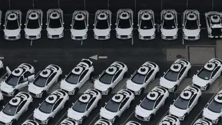 Getty Images An overhead view of a fleet of white Waymo vehicles