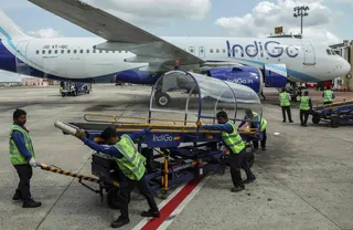Ground staff members prepare an IndiGo Airlines plane for take-off at Biju Patnaik International Airport in Bhubaneswar on May 8. Photo: AFP