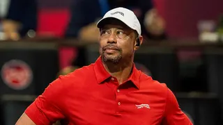 Tiger Woods watching a teammate tee off during a golf match at SoFi Center