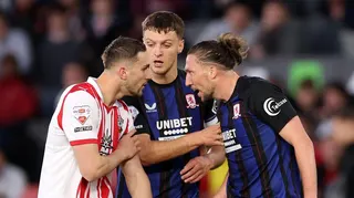 Taylor Harwood-Bellis (left) is confronted by Luke Ayling (right) with Middlesbrough captain Dael Fry in the middle trying to intervene