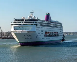 The Ambassador Cruise Line vessel Ambassador in a port city