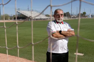 Amir Pajouyan, a member of the Iranian diaspora in Tucson, poses wearing an Iran jersey at the Kino Sports Complex, where Iran's national football team Team Melli will train during the 2026 FIFA World Cup, in Tucson, Arizona, on May 6, 2026. In the Strait of Hormuz, US warships menace Iran's oil tankers. In Washington, President Donald Trump threatens nothing less than "complete victory" will suffice. But in Tucson, they're getting ready to welcome the Iranian football team as if nothing were am