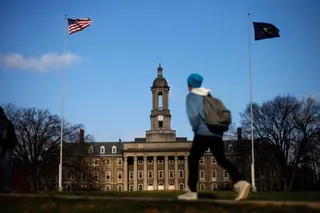 Image: A students walks in front of the Old Main building on the Penn State University campus Friday, Nov. 11, 2011, in State College, Pa.