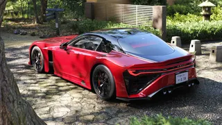 Forza Horizon 6 launch time date: A red car parked on cobbled ground in a forest.