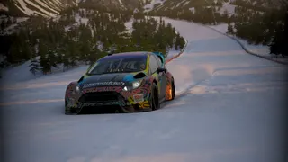 Ford rally car in the snow kicking up diamond dust behind it as it descends a winter slalom slope in Forza Horizon 6