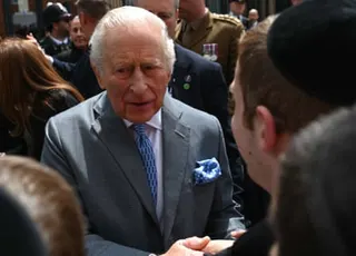 King Charles shaking hands with someone.