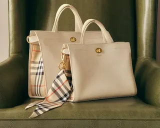 Two white handbags on a green chair
