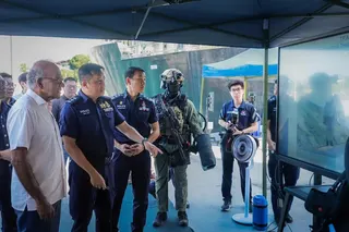 Home Affairs Minister K. Shanmugam watching a demonstration on the jet-propelled manpack at the Police Coast Guard’s Brani Base on May 14.