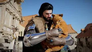 Kliff with an orange cat in his arms, petting it.