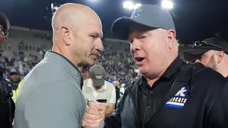 Kentucky head coach Mark Stoops and Vanderbilt head coach Clark Lea meeting on football field