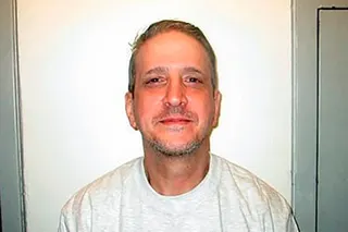 Richard Glossip looks directly at the camera in a white t-shirt