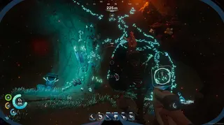 An underwater cave lit by magma and bioluminescence in Subnautica 2