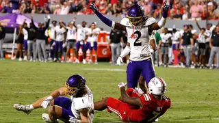 Ja'Marley Riddle reacting on the field during a football game at Carter-Finley Stadium