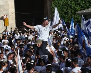 People holding Israeli flags during Jerusalem Day march
