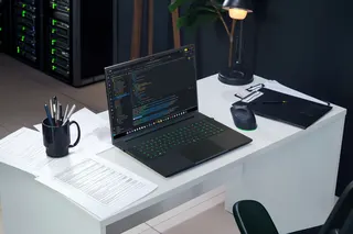 <em>That’s a big laptop. Or a small desk. Definitely both.</em>
