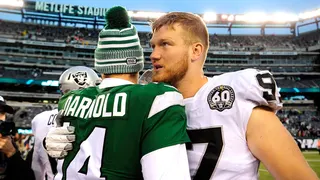 Quarterback Sam Darnold greeting defensive end Josh Mauro on football field