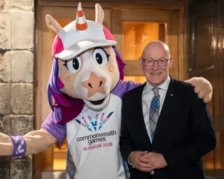 Scotland's first minister John Swinney with the Commonwealth Games mascot Finnie