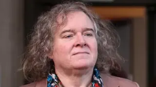 Reuters A middle aged woman with long curly grey hair wearing a colourful scarf