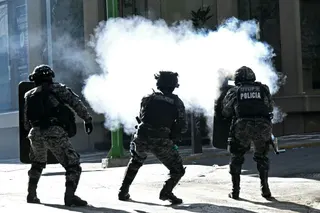 Riot police fire tear gas at miners during a march to demand the resignation of Bolivian President Rodrigo Paz, in La Paz, on May 14, 2026.