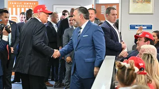 President Donald Trump shaking hands with Sen. Ted Cruz inside a Whataburger restaurant