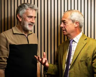 Nigel Farage gestures as he speaks with Christopher Harborne