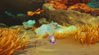 Subnautica 2 quartz: A quartz crystal on a piece of coral on the seabed, with a strange sea slug-like creature next to it.