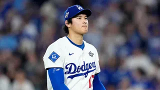 Shohei Ohtani walking to the dugout during a baseball game.