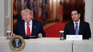 President Donald Trump and Secretary of State Marco Rubio seated during a roundtable in the White House East Room