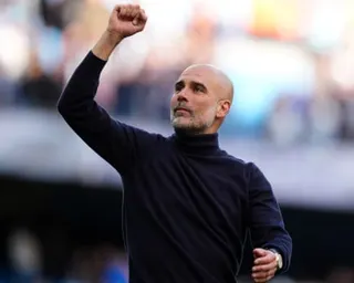 Pep Guardiola fist pumps towards Manchester City fans