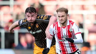 Hull defender Charlie Hughes has his left hand on the right shoulder of Southampton player Leo Scienza, who is wearing gloves