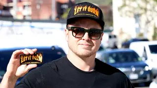 Spencer Pratt wearing a Newsom hat and sticker in Pacific Palisades, California