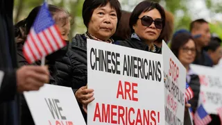Supporters of Lu Jianwang stand outside a federal courthouse before the opening of his trial in New York