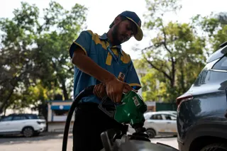 A petrol pump attendant fills fuel in a bike in New Delhi, India.