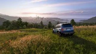 A 4x4 parked on a hillside with a panoramic view of Tokyo