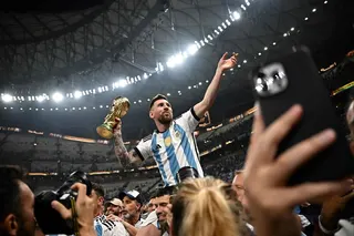 Argentina’s captain Lionel Messi (centre) holds the World Cup after beating France in the 2022 final in Qatar. Photo: AFP