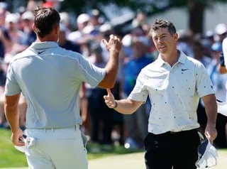 Rory McIlroy moves to shake hands with Brooks Koepka