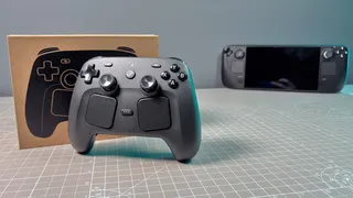 The Steam Controller on a desk during a teardown, with various parts removed.