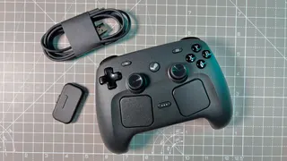 The Steam Controller on a desk during a teardown, with various parts removed.