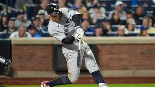 New York Yankees' Aaron Judge hitting a double during a baseball game.