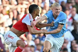 Arsenal's French defender #02 William Saliba (L) fights for the ball with Manchester City's Norwegian striker #09 Erling Haaland (R) during the English Premier League football match between Arsenal and Manchester City at the Emirates Stadium in London on September 21, 2025.