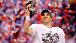Quarterback Eli Manning holding the Vince Lombardi Trophy at Lucas Oil Stadium