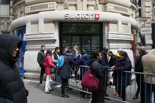 Clients queue in front of a closed Swatch shop in Paris. Photo: AFP