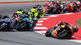 Pedro Acosta, Alex Marquez, and Raul Fernandez racing on motorcycles at Circuit de Barcelona