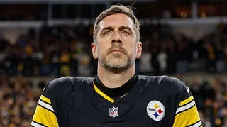 Aaron Rodgers looks on during the national anthem before his Pittsburgh Steelers team loses to the Houston Texans in the NFL play-offs in 2026